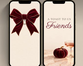 May include: Two smartphones displaying an animated invitation. The left screen shows a large dark red velvet bow with gold trim. The right screen features the text A TOAST TO US Friends, a dark red velvet pumpkin, and a glass of pink champagne.