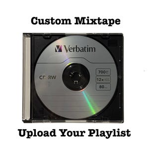 May include: A CD-RW disc in a black case with the text "Custom Mixtape" and "Upload Your Playlist". The disc is silver with the "Verbatim" logo and specifications for 700 MB, 12X speed, and 80 min. The case is clear on the front.