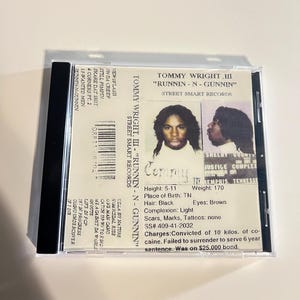 May include: A clear plastic CD case containing a CD with the album title "RUNNIN - N - GUNNIN" by Tommy Wright III. The album cover features a photo of the artist and text with biographical information.