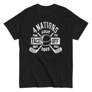 May include: Black t-shirt with a white graphic of hockey sticks crossed behind a puck. The graphic reads "4 Nations 2025 Face-Off 2025" with the country abbreviations "CAN SWE FIN USA".