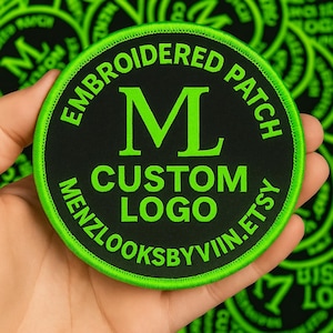 May include: Circular black embroidered patch with a neon green border. The patch displays the text "EMBROIDERED PATCH", "CUSTOM LOGO", and "MENZLOOKSBYVIIN.ETSY" in a circular arrangement around a large green "M".