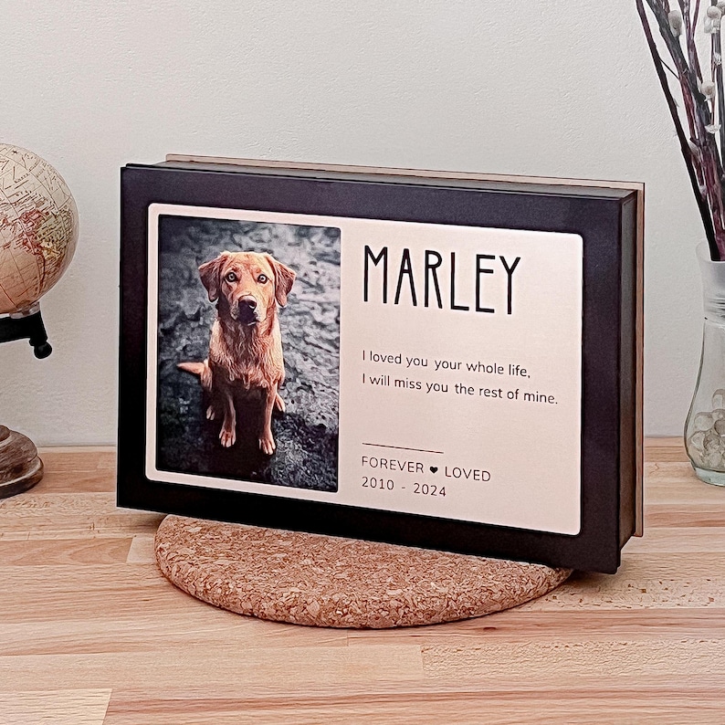 May include: A black wooden box with a photo of a brown and white dog named Marley. The text reads "I loved you your whole life, I will miss you the rest of mine. Forever Loved 2010-2024".