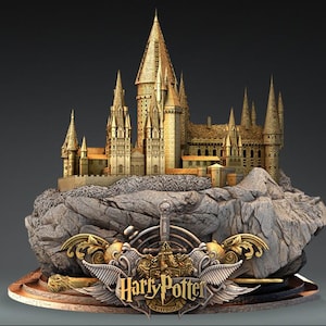 May include: A golden model of Hogwarts castle sits on a rocky base. The castle is detailed with towers and windows. The base has a silver sword and wings with the words "Harry Potter" and "Gryffindor" in gold.