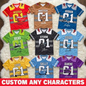 May include: A collection of colorful jersey-style shirts featuring various characters and the text "CUSTOM ANY CHARACTERS". Each shirt has a character name, a number "01", and a corresponding cartoon car graphic. Colors include red, brown, blue, green, black, yellow, light blue, and purple.