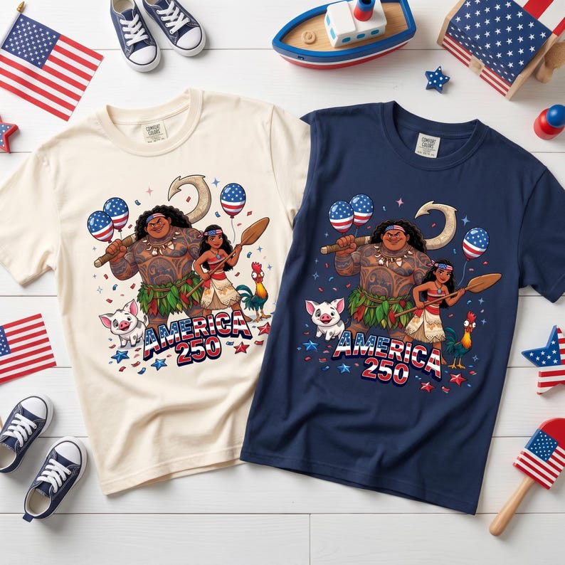 May include: A cream-colored t-shirt and a navy blue t-shirt, each featuring a graphic print of two animated characters, a pig, and a rooster. The design includes American flag-patterned balloons, a hook, and the text America 250 in red, white, and blue.