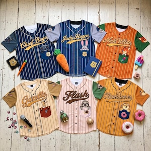May include: Six baseball jerseys with character names and images from a movie. The jerseys are navy, orange, tan, and pink with vertical stripes. Each jersey has a pocket with a character image and a matching accessory.