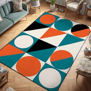 Puede incluir: Alfombra geométrica abstracta con fondo blanco, con formas turquesa, naranja y negras. La alfombra tiene un diseño moderno con círculos, triángulos y cuadrados.