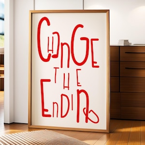 May include: A white framed poster with the text "Change the Ending" written in red cursive lettering.