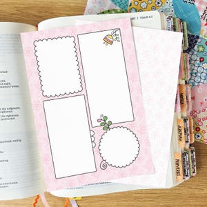 May include: A light pink paper insert featuring a repeating white floral pattern, containing four blank white spaces for writing: one scalloped rectangle, one plain rectangle with a small flower icon, one plain rectangle, and one scalloped circle.