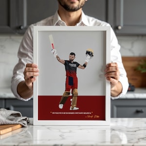 May include: A framed print featuring a stylized illustration of a cricket player in a black and red uniform, holding a bat and helmet. The print includes a quote by Virat Kohli and is set against a white and red background.