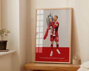 May include: Framed print featuring a soccer player in a red uniform holding a trophy. The print has a red and gray background with the text "PLAY LIKE A CHAMP, WIN LIKE A CHAMP, ACT LIKE A CHAMP - Jordan Henderson."