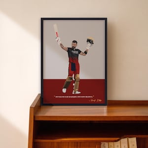 May include: A framed art print featuring a cricket player in a red and black uniform, holding a bat and helmet. The artwork has a minimalist style with a red and gray background. The print includes a quote and signature.