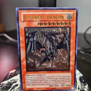 Dragão do Julgamento - Raro Supremo - Orica Proxy - TU01-EN000 - Raro Luz Estelar - Segredo Prismático - Comum - Único ou Conjunto
