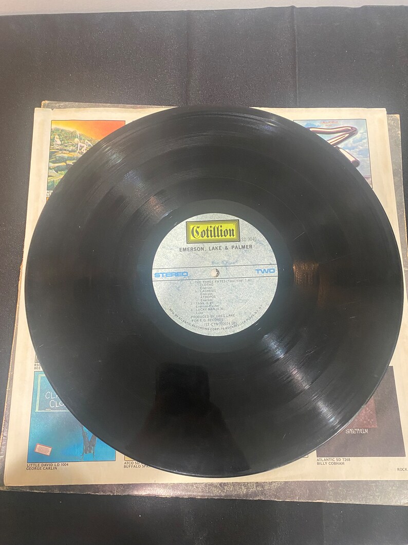 May include: Black vinyl record with a Cotillion Records label. The label features the text "Cotillion", "SD 9040", "Emerson, Lake & Palmer", "Stereo", and "Two".