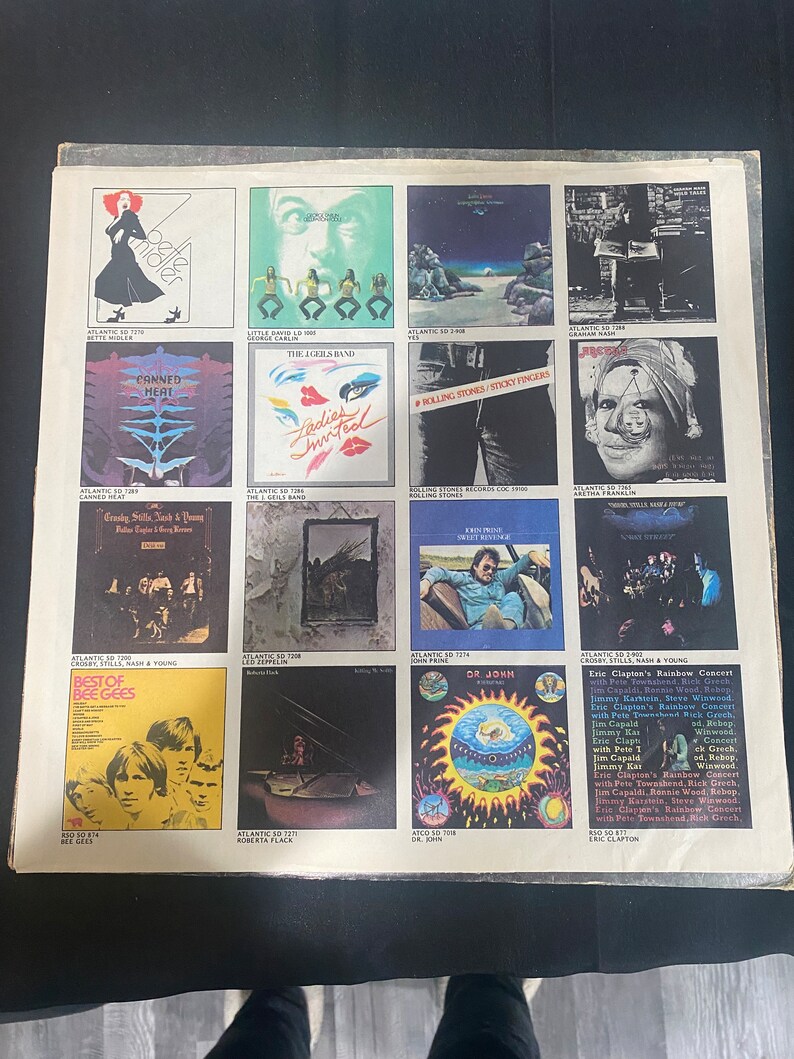 May include: A collage of album covers featuring various artists, including Bette Midler, The Eagles, The Rolling Stones, Canned Heat, The Iggles Band, Crosby, Stills, Nash & Young, Bee Gees, Roberta Flack, Dr. John, and Eric Clapton. The album covers are arranged in a grid pattern and feature a variety of colors and designs.