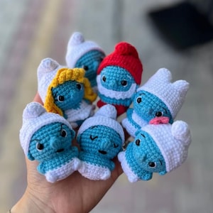 Little blue characters living in a mushroom house in the forest