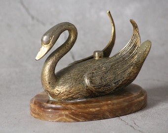 Base for a lamp or candlestick in the shape of a swan on a marble stand.