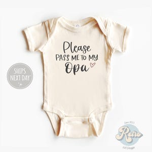 May include: A white baby onesie with the text "Please pass me to my Opa" in black with a small pink heart.