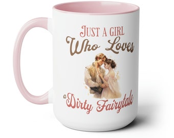 May include: White ceramic mug with a pink interior and handle. The mug features the text "JUST A GIRL Who Loves a Dirty Fairytale" in brown and red script, along with a watercolor illustration of a couple.