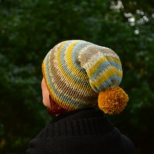 Double-layered beanie with mustard bobble for winter.