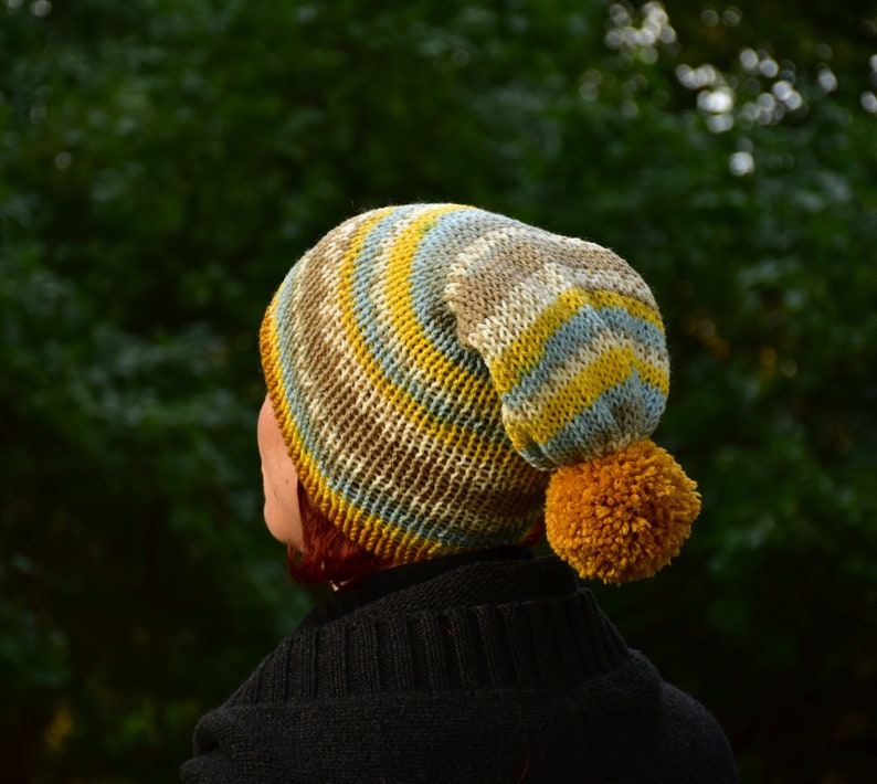 Double-layered beanie with mustard bobble for winter.