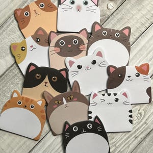 May include: A set of 10 colorful cat-shaped sticky notes with different expressions. The notes are perfect for adding a touch of whimsy to your planner, journal, or desk.