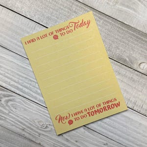 May include: A yellow lined notepad with the text "I had a lot of things to do Today" at the top and "Now I have a lot of things to do Tomorrow" at the bottom.