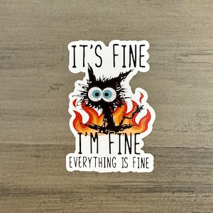 May include: A white sticker with a black cat on fire and the text "It's fine, I'm fine, everything is fine."