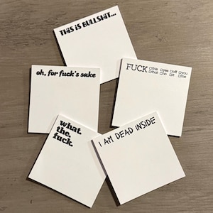 May include: A collection of white sticky notes with black handwritten text. The notes display phrases like "THIS IS BULLSHIT...", "oh, for fuck's sake", "what. the. fuck.", "I AM DEAD INSIDE", and "FUCK".
