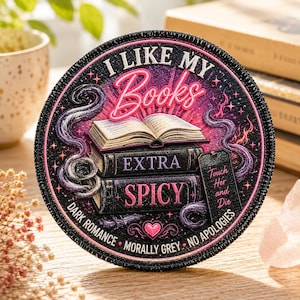 May include: Round patch with the text "I LIKE MY Books EXTRA SPICY" and other phrases. The patch features a stack of books, an open book, and purple tentacles. The design is black, pink, and purple.
