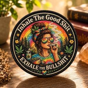 May include: Round patch with the text "Inhale The Good Shit, Exhale The Bullshit." The patch features a woman with sunglasses smoking a cigarette, set against a rainbow and forest background. The design includes cannabis leaves and flowers.
