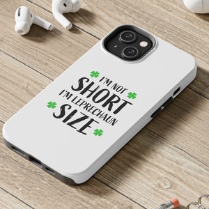 May include: White phone case with a green shamrock design and the text "I'm not short I'm Leprechaun size".