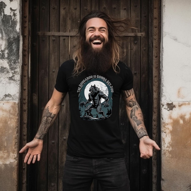 May include: A black t-shirt with a werewolf graphic and the text 'The Rougarou is gonna get you'.