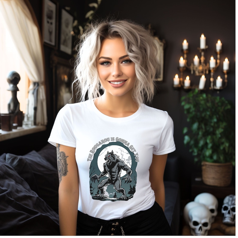May include: White t-shirt with a graphic of a werewolf howling at the moon. The text on the shirt reads "The Werewolf is Gonna Get You".
