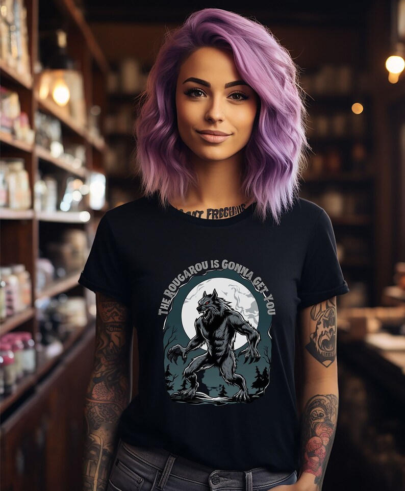 May include: Black t-shirt with a graphic of a werewolf howling at the moon. The text "The Rougarou is gonna get you" is printed on the shirt.