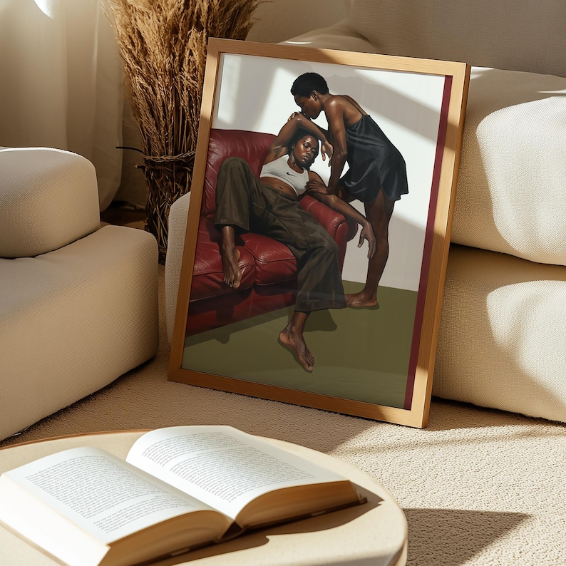 A framed poster with a black, lesbian couple kissing.
