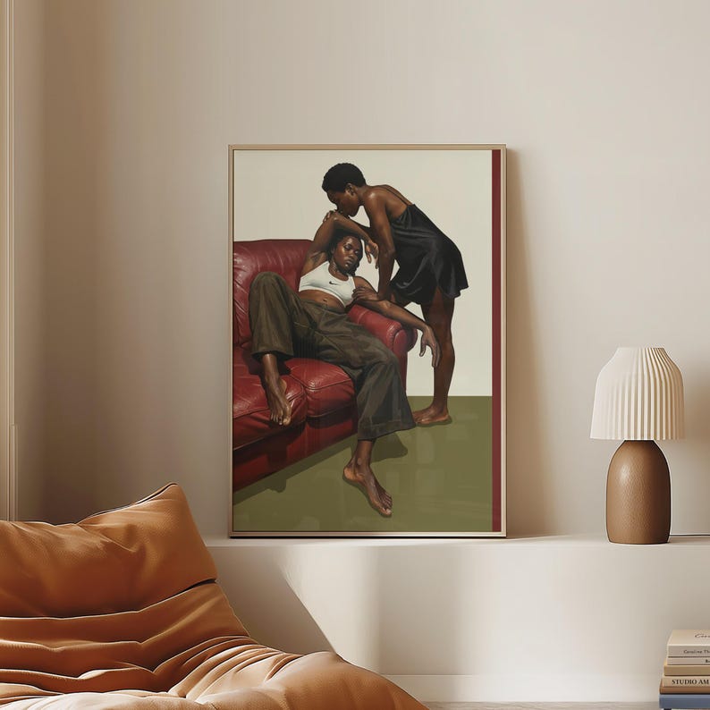 A framed poster with a black, lesbian couple kissing.