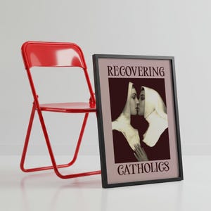 A framed poster featuring two kissing nuns, paired with the text "RECOVERING CATHOLICS."