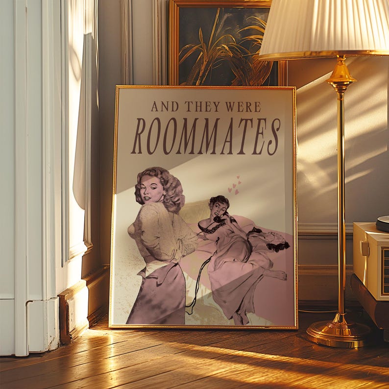 A framed print with two ladies in a romantic pose, with the text 'and they were roommates'.