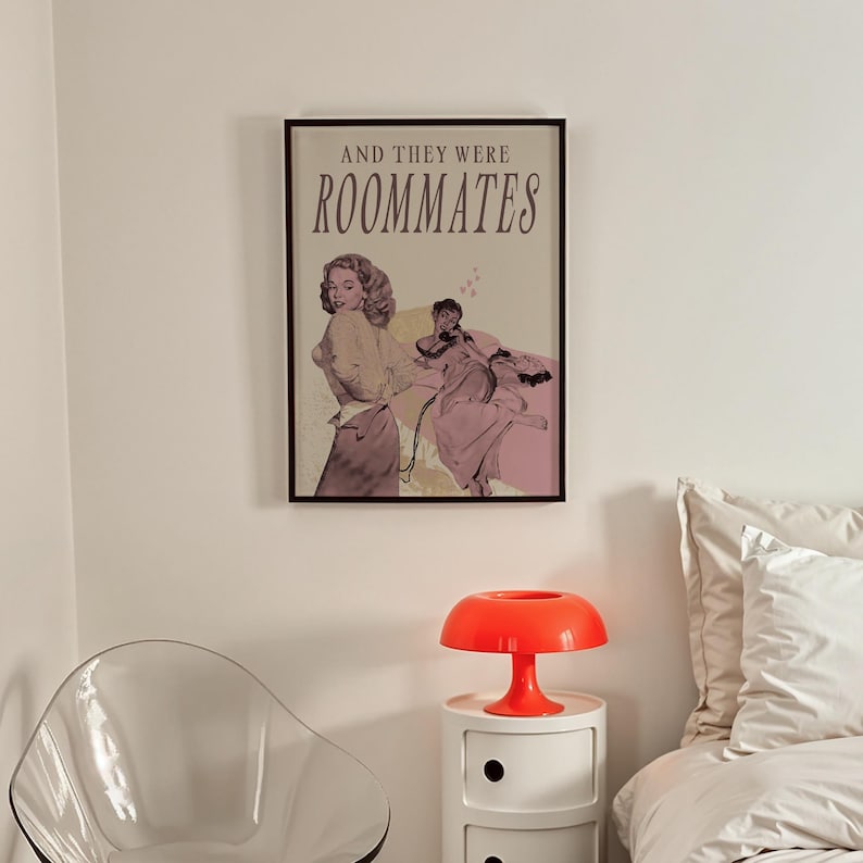 A framed print with two ladies in a romantic pose, with the text 'and they were roommates'.