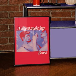 May include: Framed art print with a red background featuring two figures smoking, with the text "Don't just smoke fags Be one". The artwork has a retro, illustrative style with a color palette of red, blue, and pink.