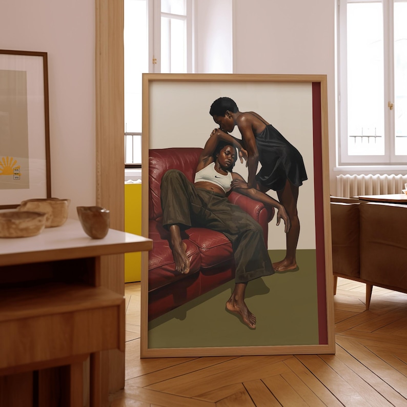 A framed poster with a black, lesbian couple kissing.