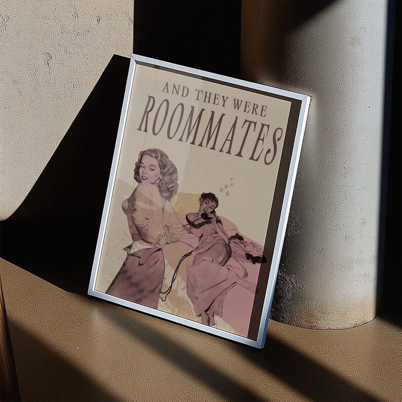 A framed print with two ladies in a romantic pose, with the text 'and they were roommates'.