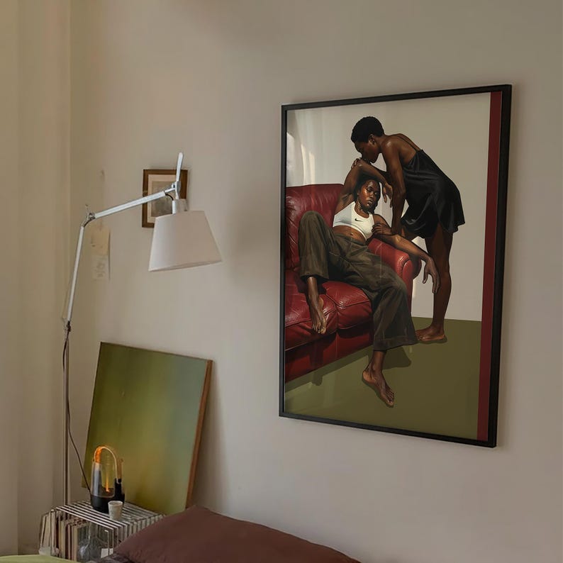 A framed poster with a black, lesbian couple kissing.