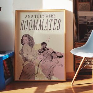 A framed print with two ladies in a romantic pose, with the text 'and they were roommates'.