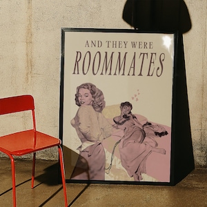 A framed print with two ladies in a romantic pose, with the text 'and they were roommates'.