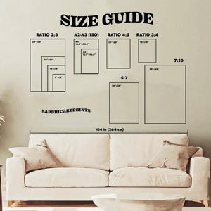 May include: A size guide chart with various rectangular shapes labeled with ratios and dimensions in inches. The text "SIZE GUIDE" is at the top. The chart is above a beige sofa, with the text "SAPPHICARTPRINTS" and "104 in (264 cm)" below.