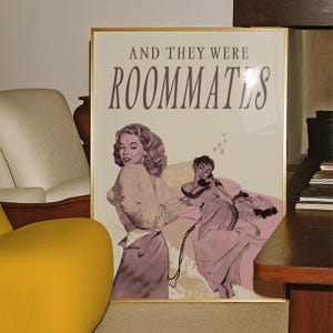 A framed print with two ladies in a romantic pose, with the text 'and they were roommates'.