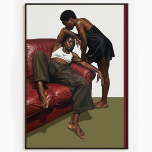 A framed poster with a black, lesbian couple kissing.