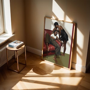 A framed poster with a black, lesbian couple kissing.
